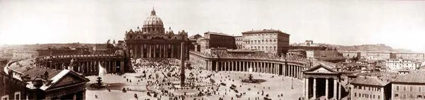 Part of the colonnade of Piazza San Pietro with St. Peter's and the Vatican Palace beyond.